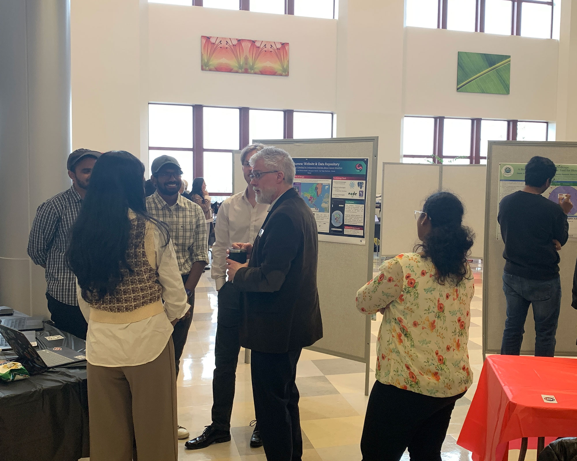 faculty and students talking at Capstone Showcase event