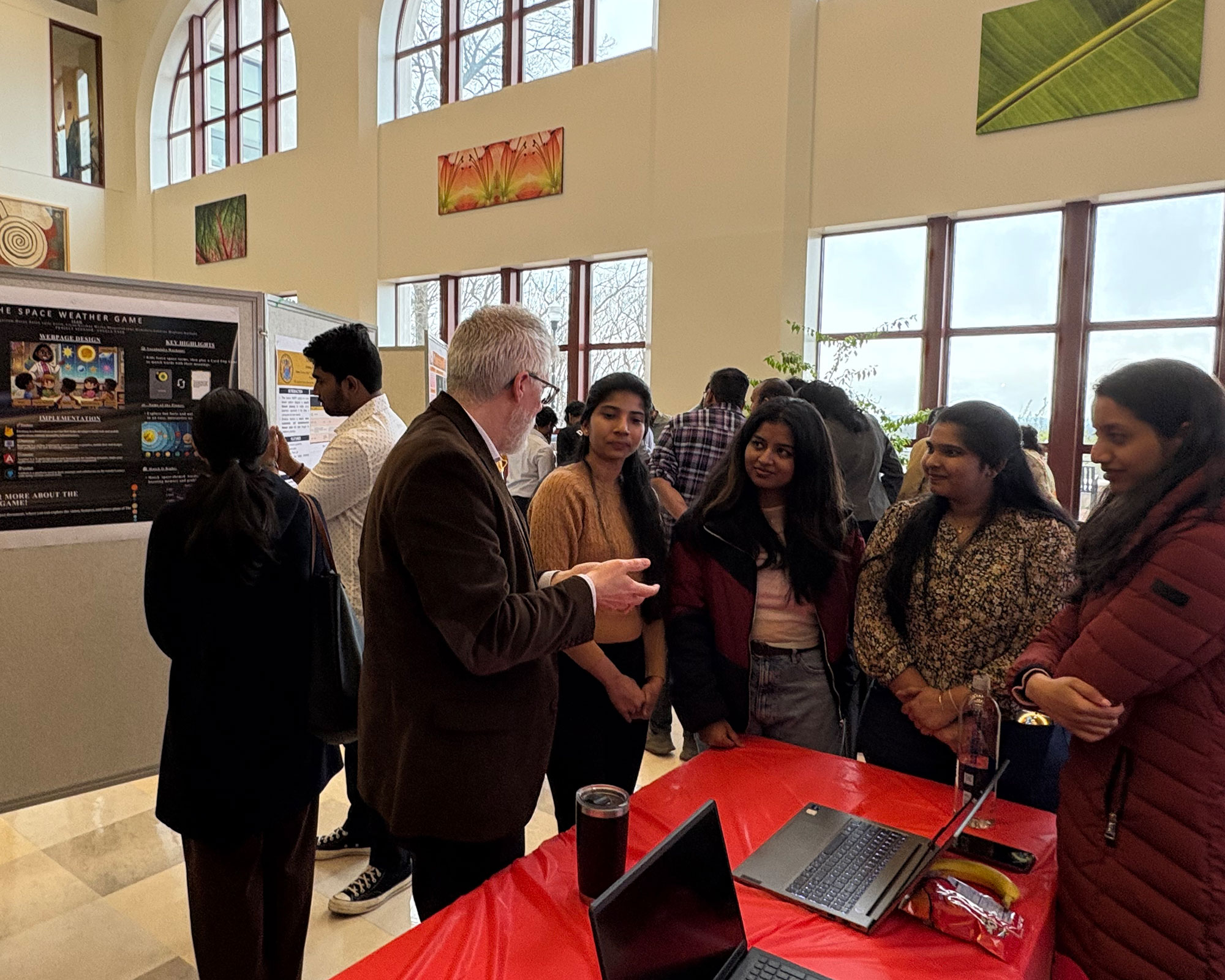 faculty and students talking at Capstone Showcase event