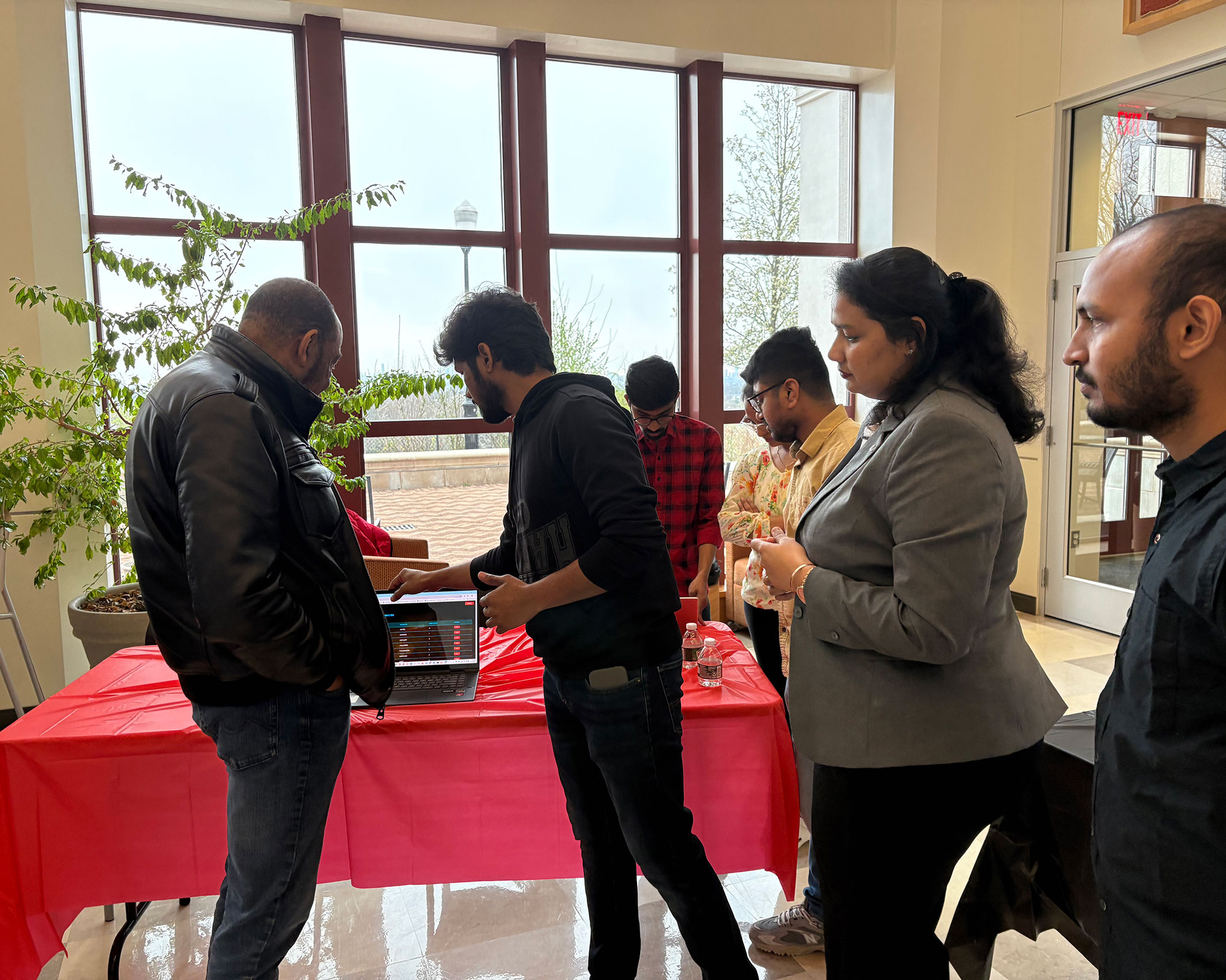 students looking at product of capstone course on table