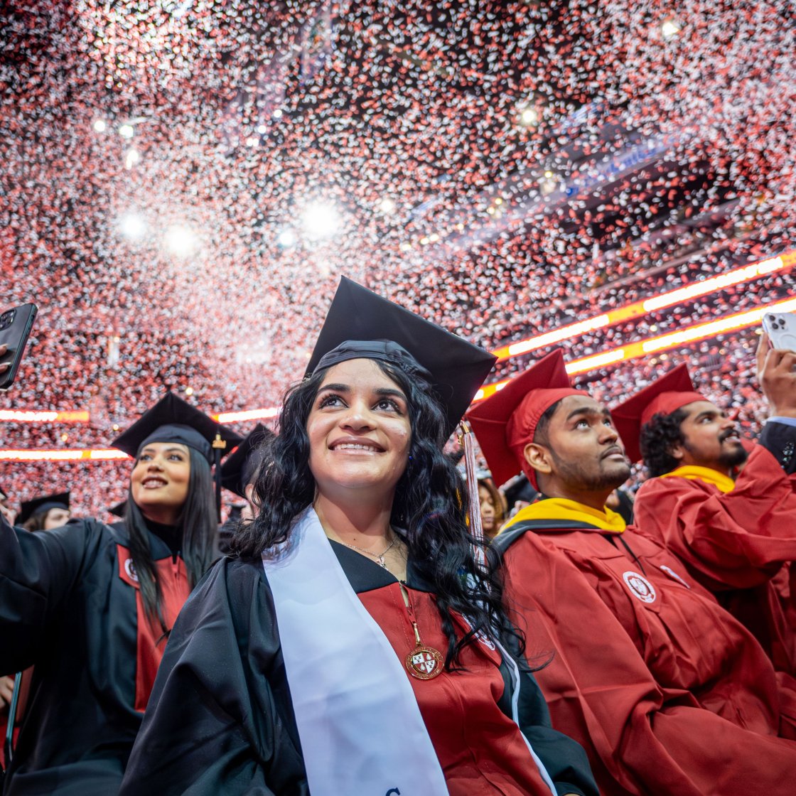 Graduates celebrate with confetti at commencement.