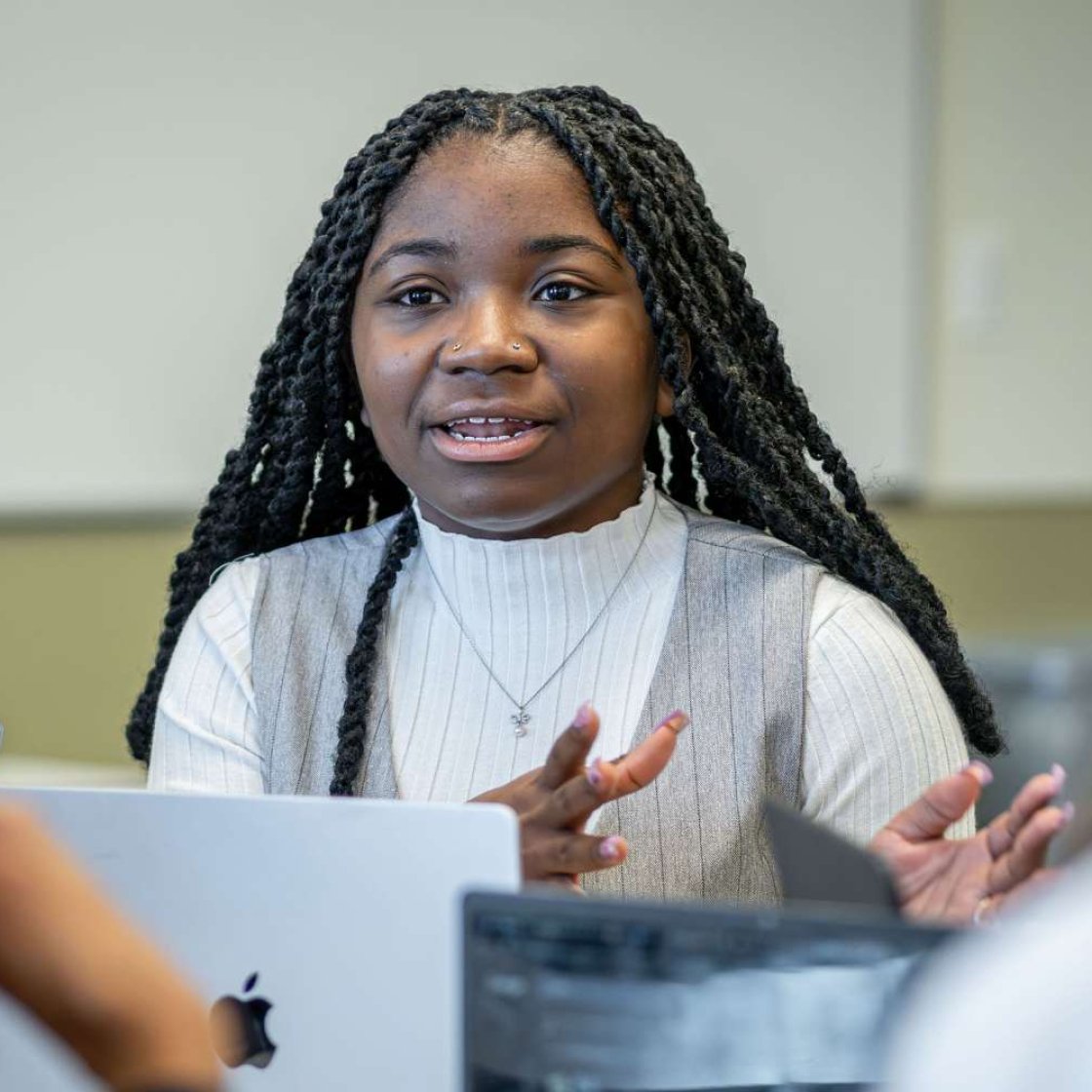 Students speaking at a table
