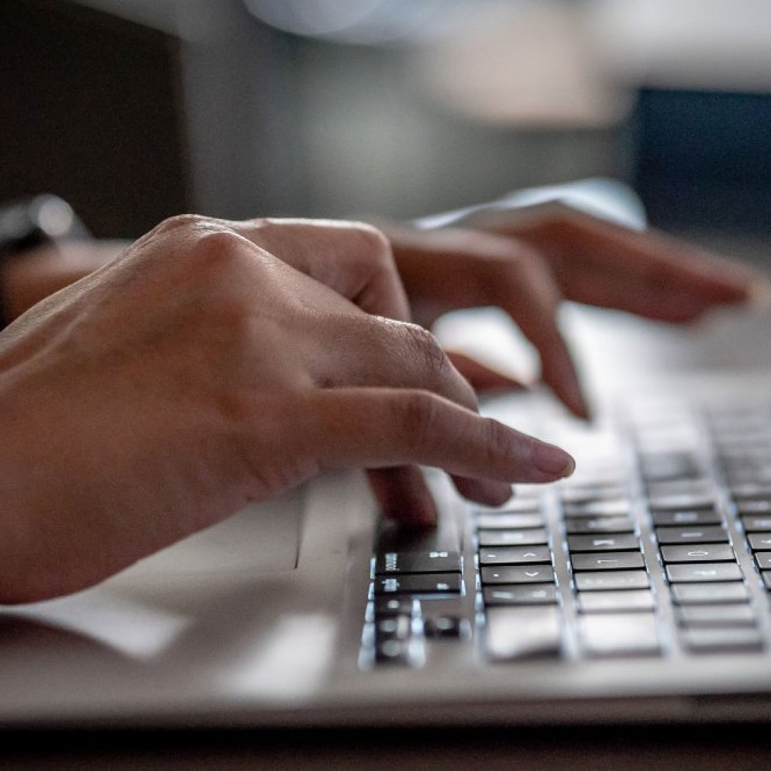 hands over a laptop keyboard