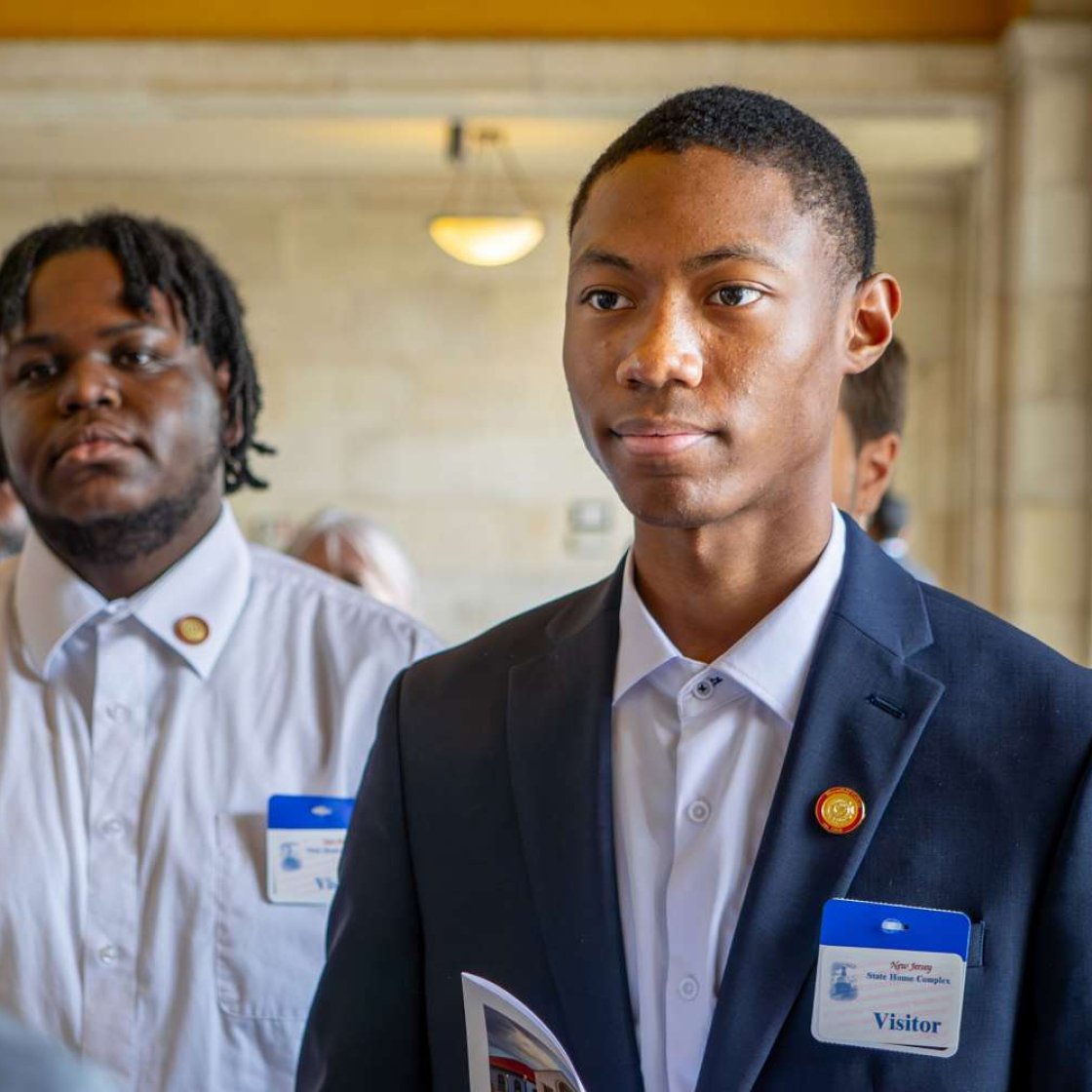Student wearing suit visiting New Jersey State House Annex.