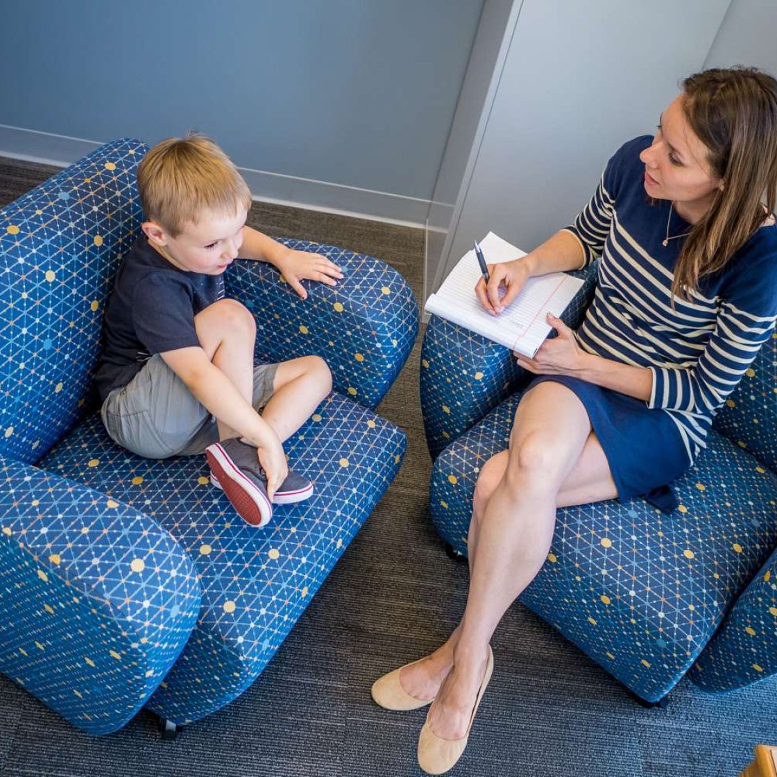 overhead view of a woman speaking with a child.
