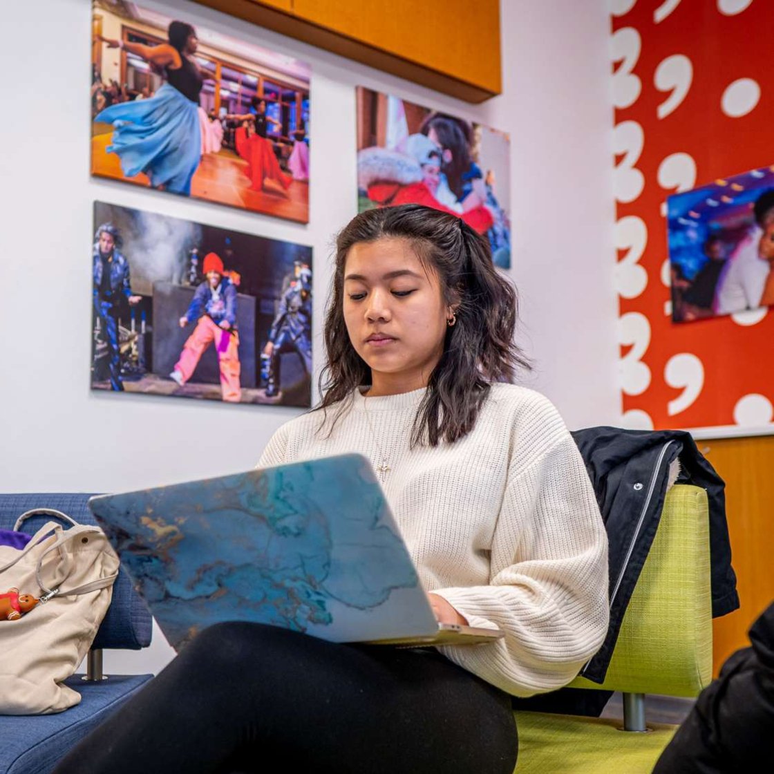 Montclair student engaged in online learning, working on a laptop in a focused, remote study environment.
