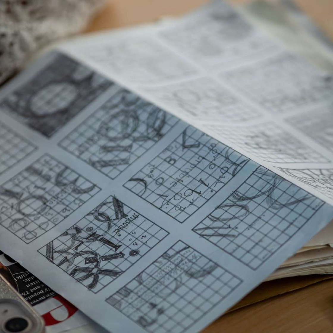 Typography sketches on graph paper.