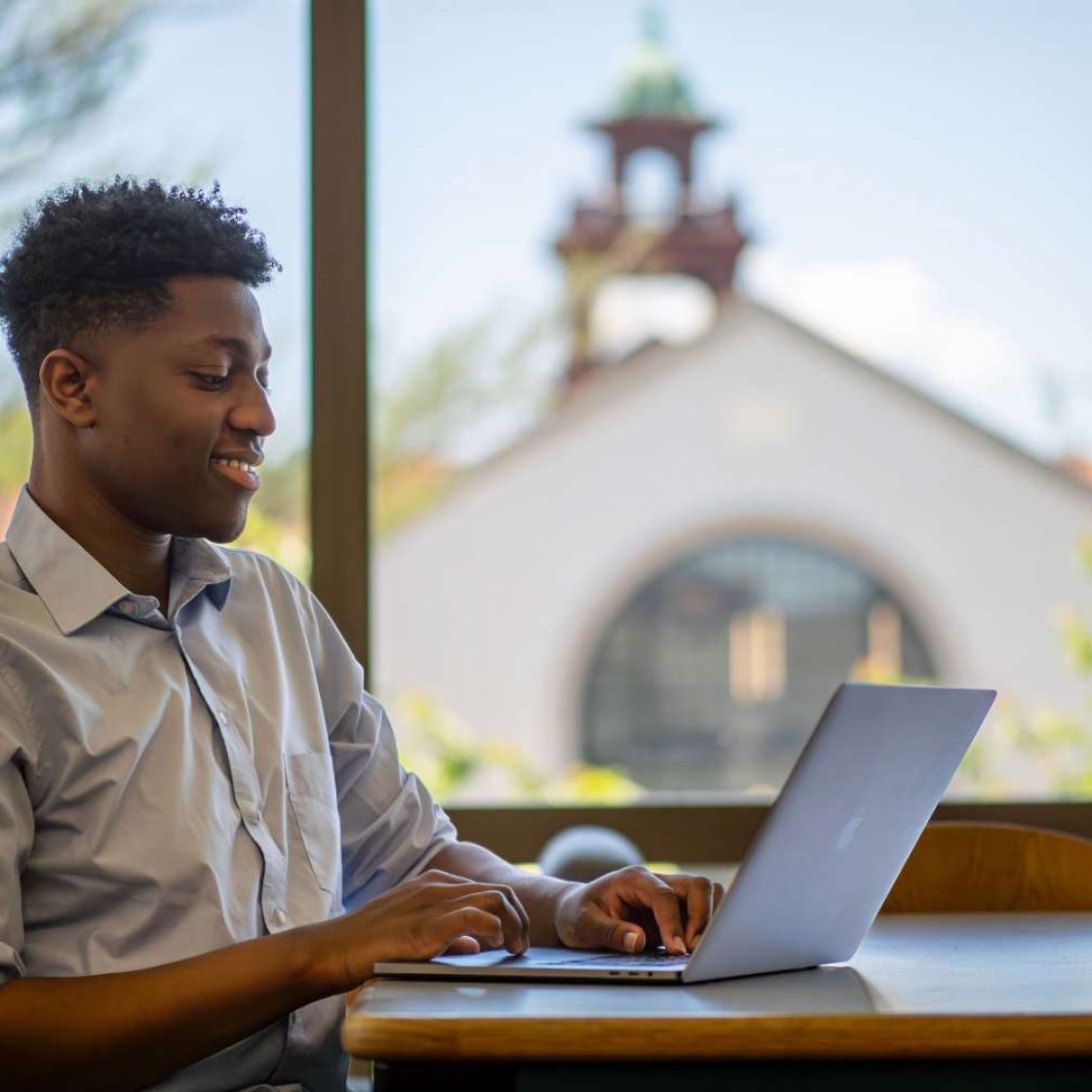 Graduate student on laptop studying.