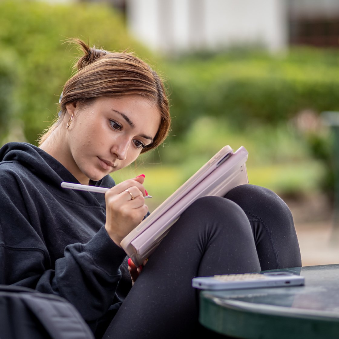 A student writes in her notebook.