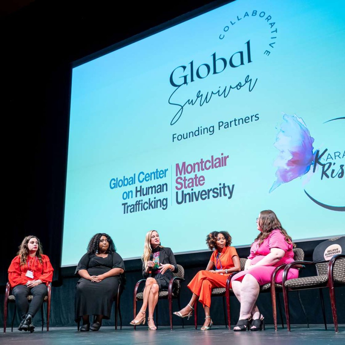 Group of panelists on stage.