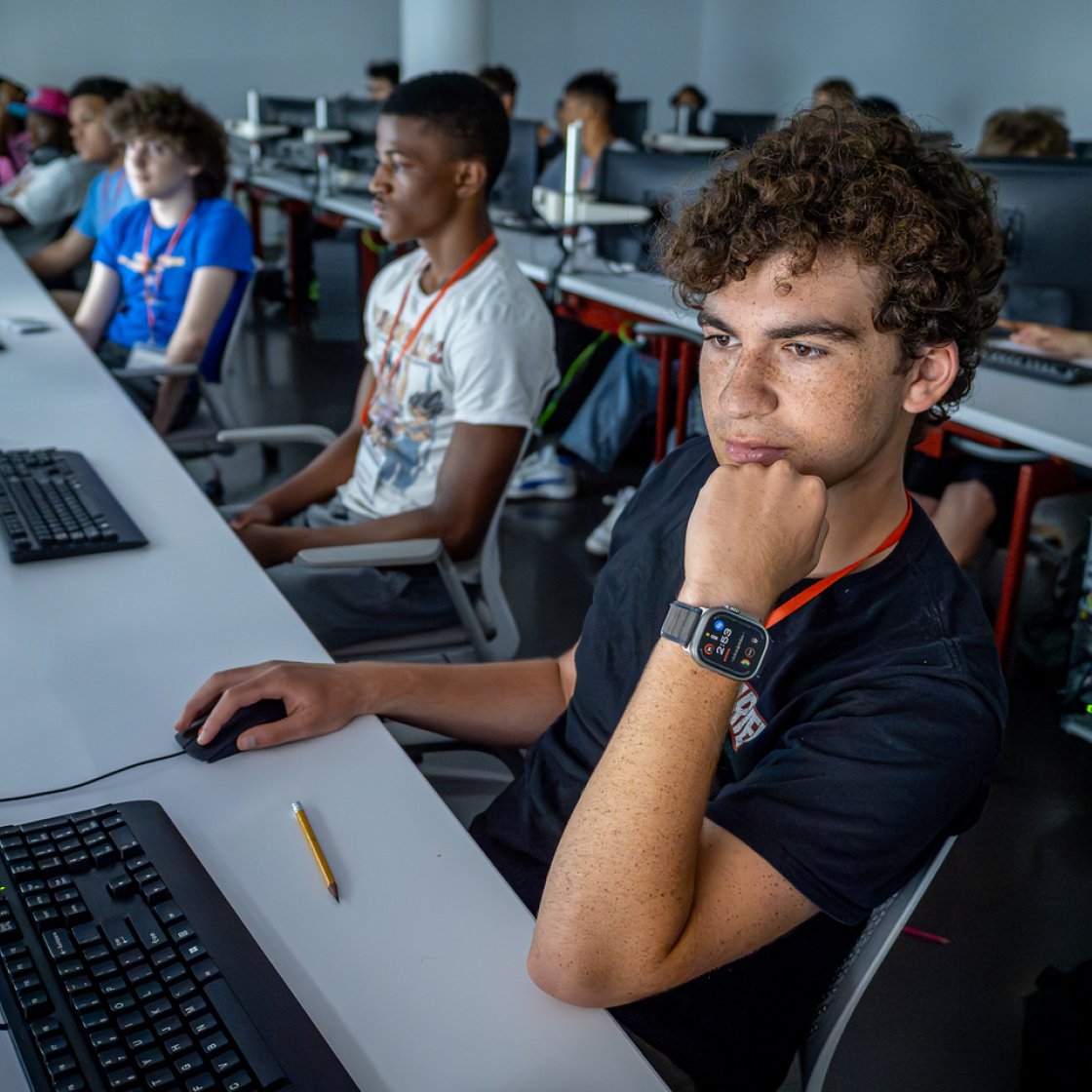 High school students sit in a classroom in front of computers during a summer class at Montclair.