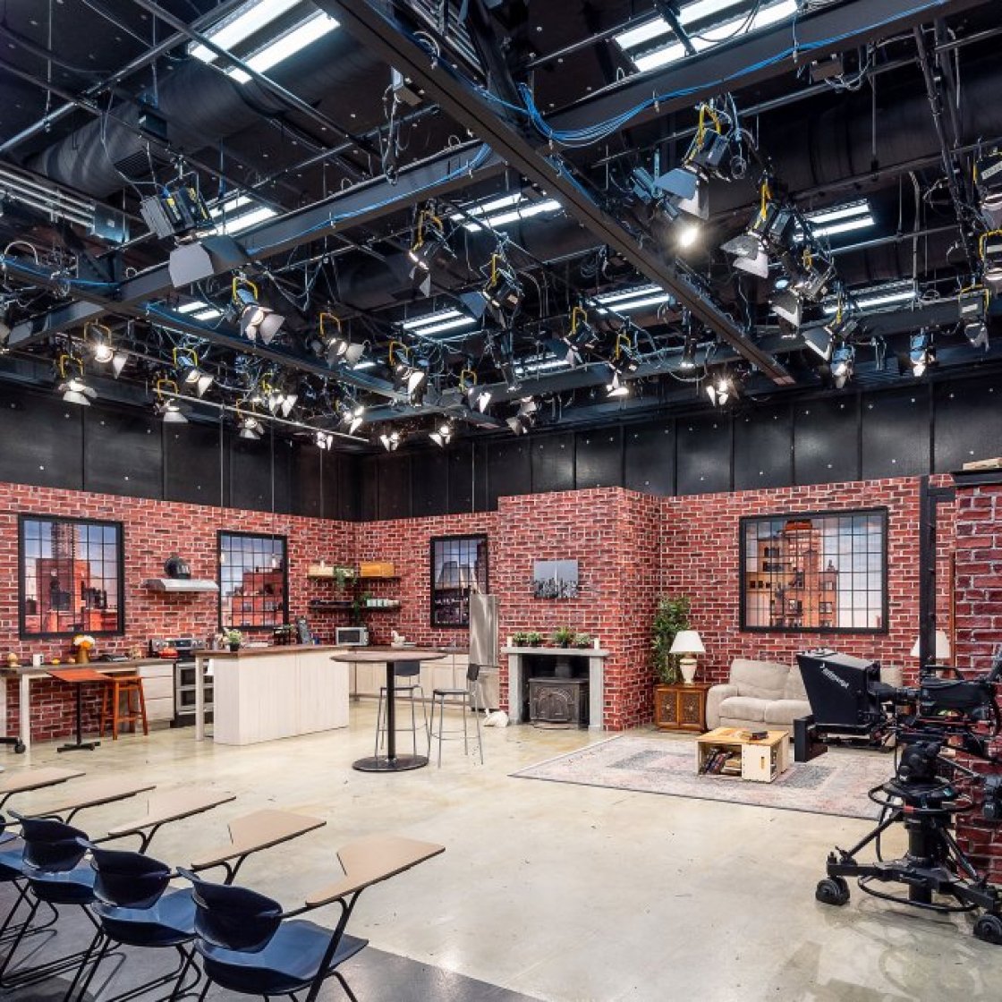 A television studio in Montclair State University, stage set shows a kitchen, fireplace and living room arrangement