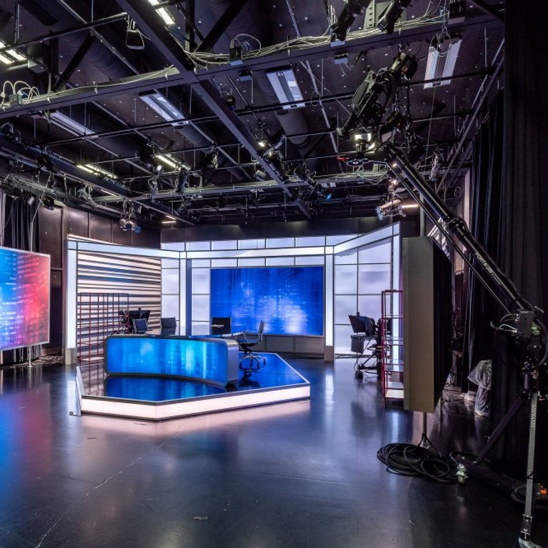 A television studio in Montclair State University, stage set shows a kitchen, fireplace and living room arrangement