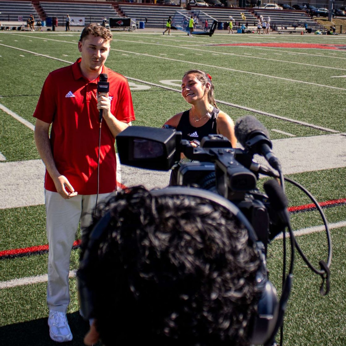 Student interviewing a student athlete.