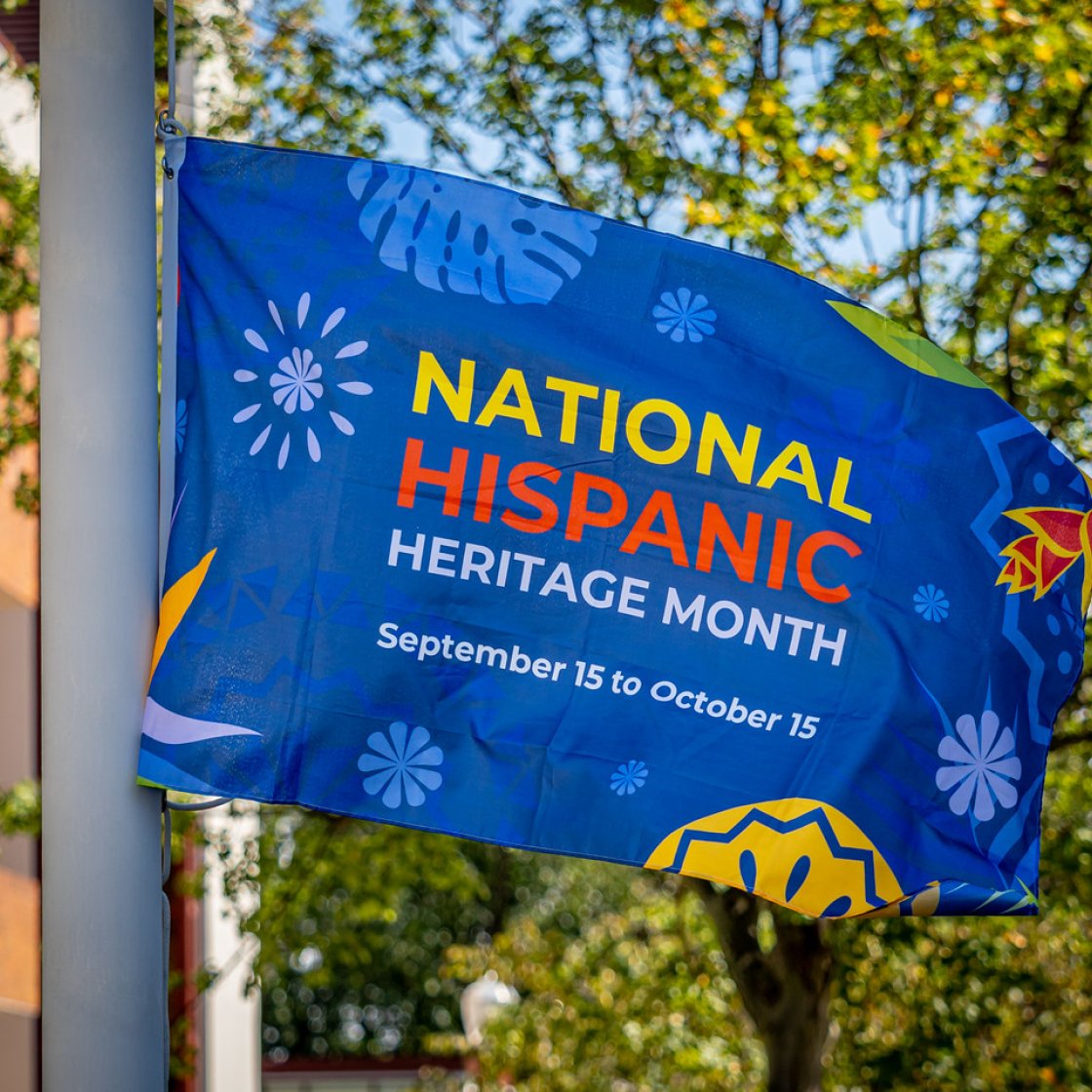 Flag raised with the words "National Hispanic Heritage Month"