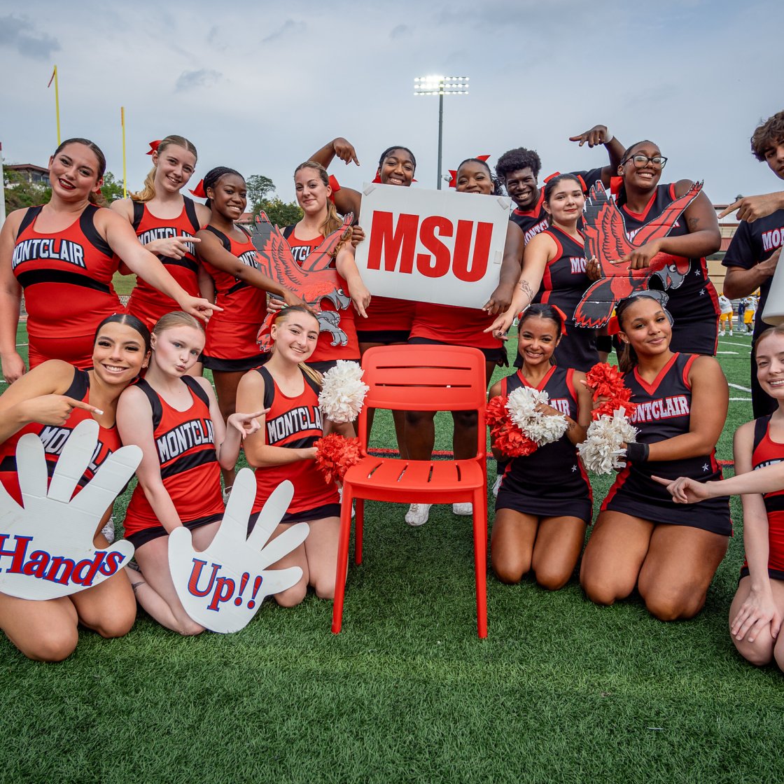 Montclair State University cheer and dance teams celebrate together on the field at Homecoming.