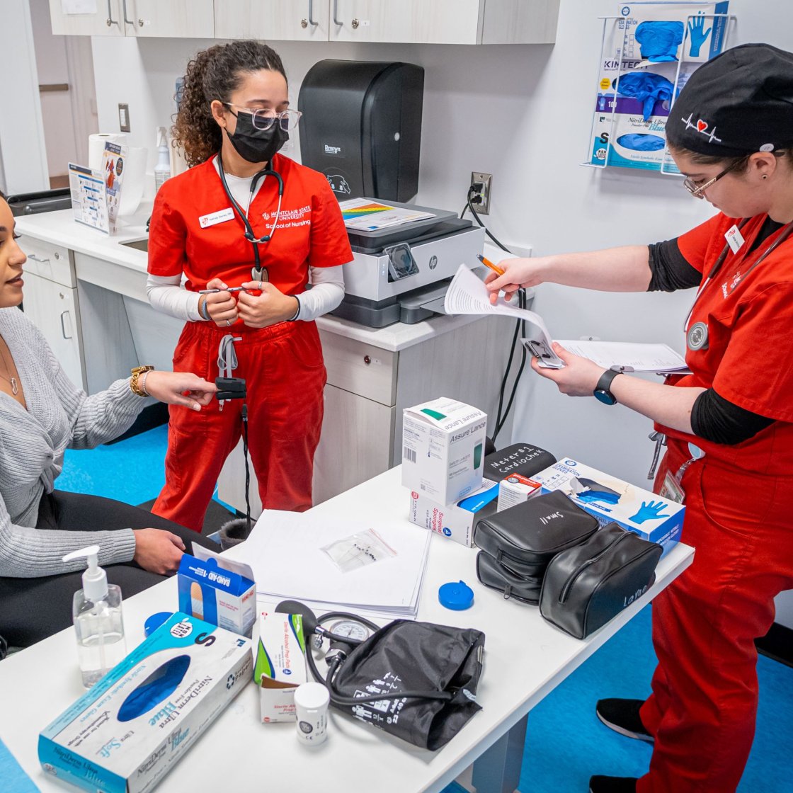Three nursing students are collaborating together.
