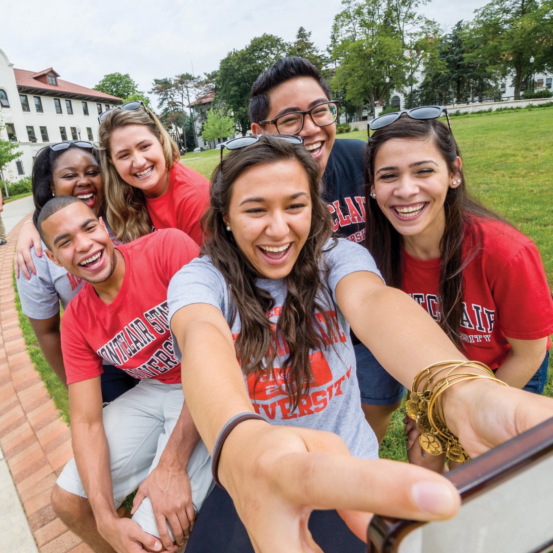 Group of students taking a selfie smiling and posing. 