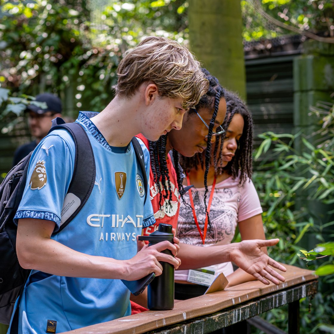 Students stand on a bridge during a Pre-College Summer Program outing.