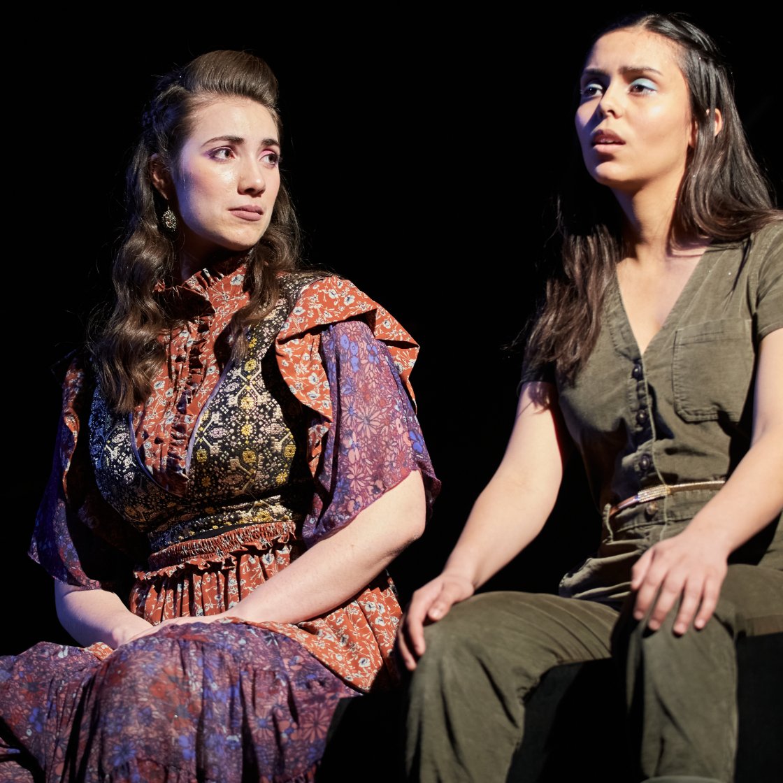 Two female students on stage performing.