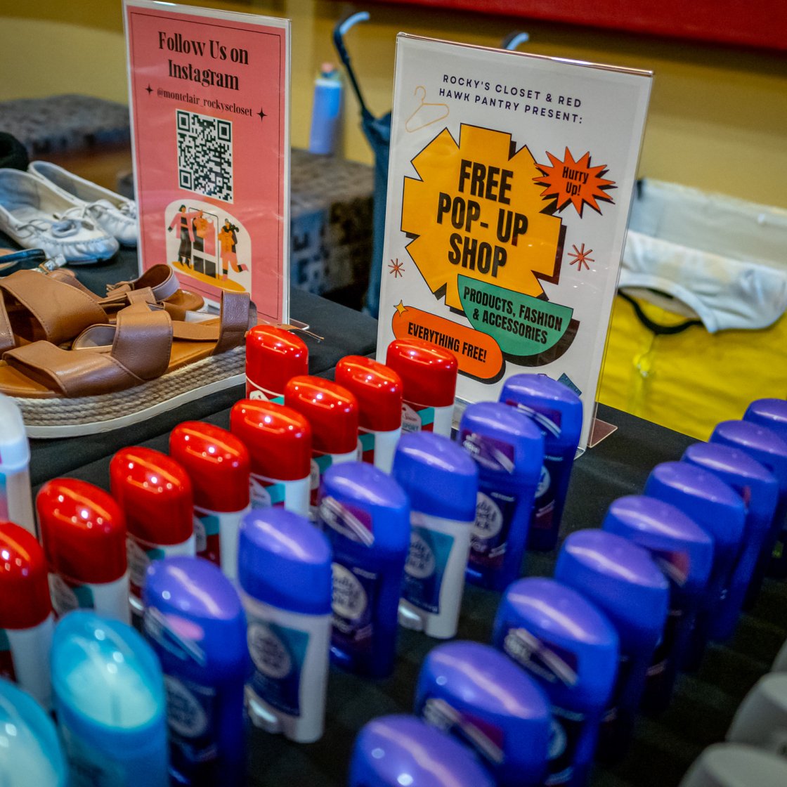 Pop up table with deodorant and essentials on table.