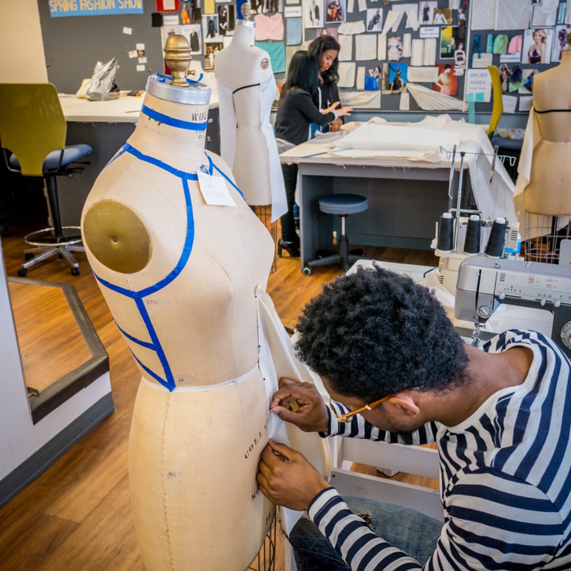 Student is taking measurements on a manniquen.