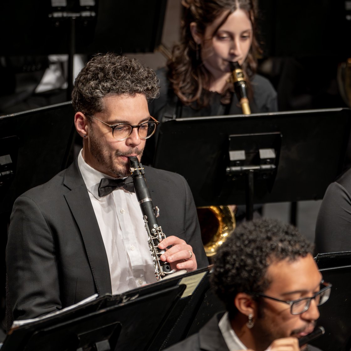 Students on stage playing instruments.