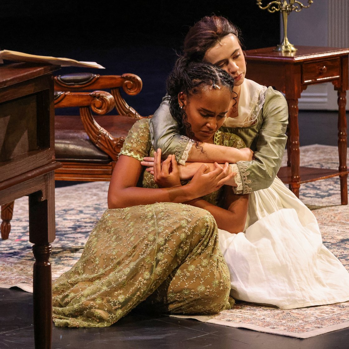Two performers on stage enacting the pride and prejudice play.
