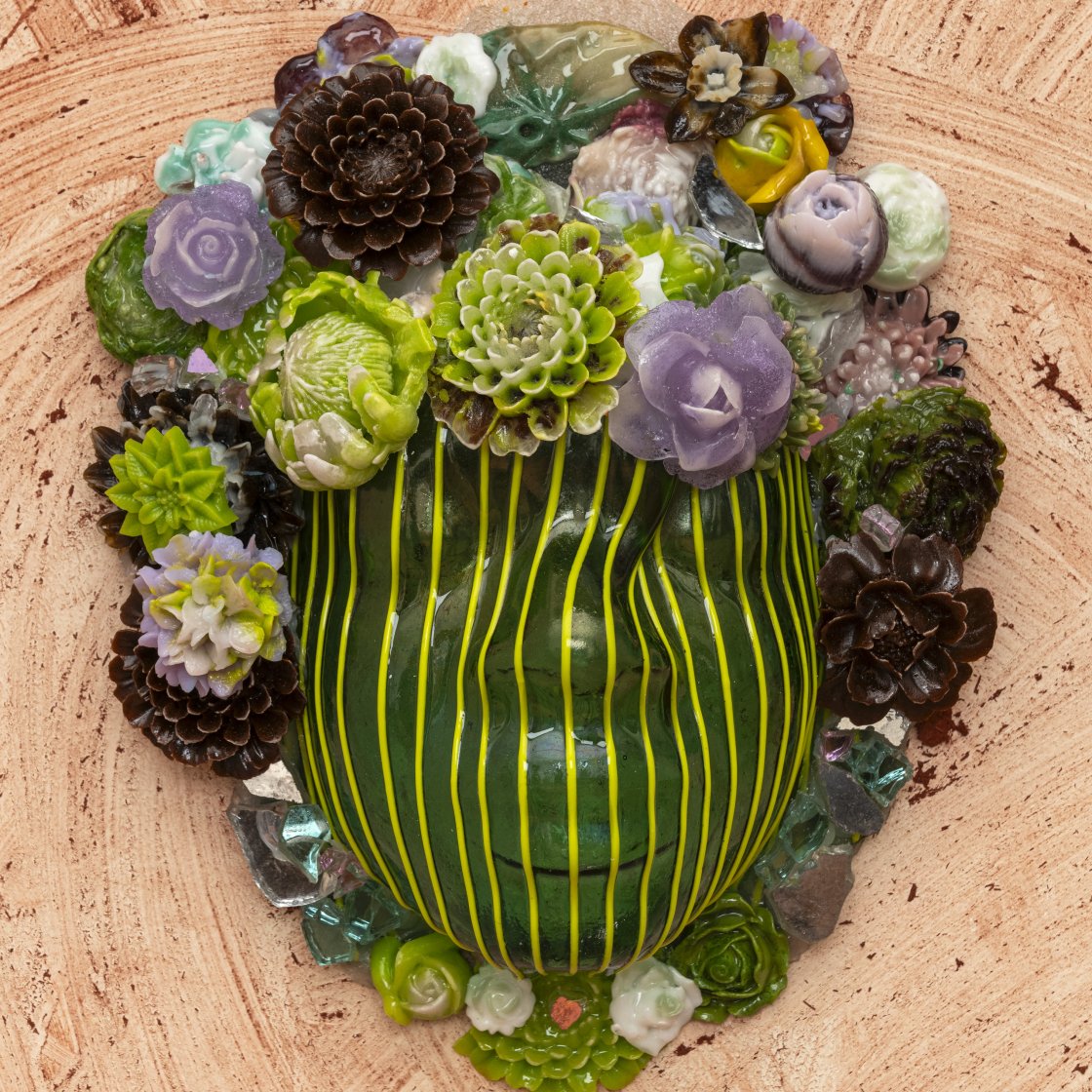 Green mask with different colored flowers for a crown.