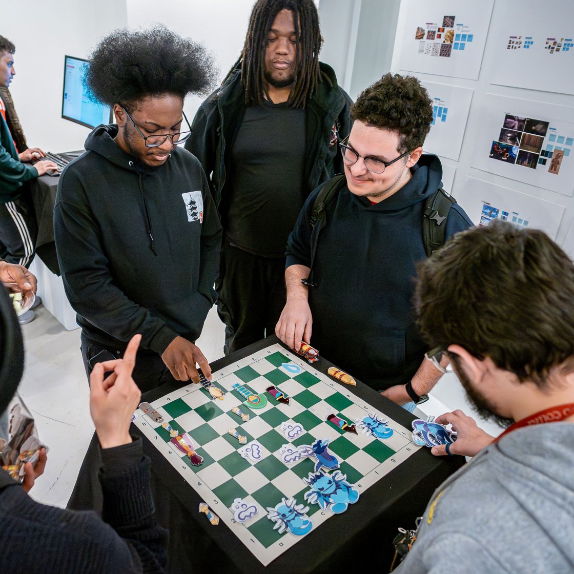 Students gathered around a game board