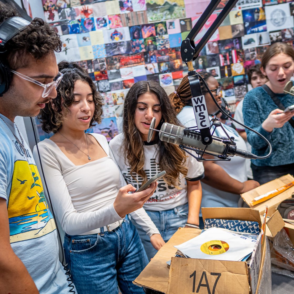 Group of students selecting records in WMSC studio