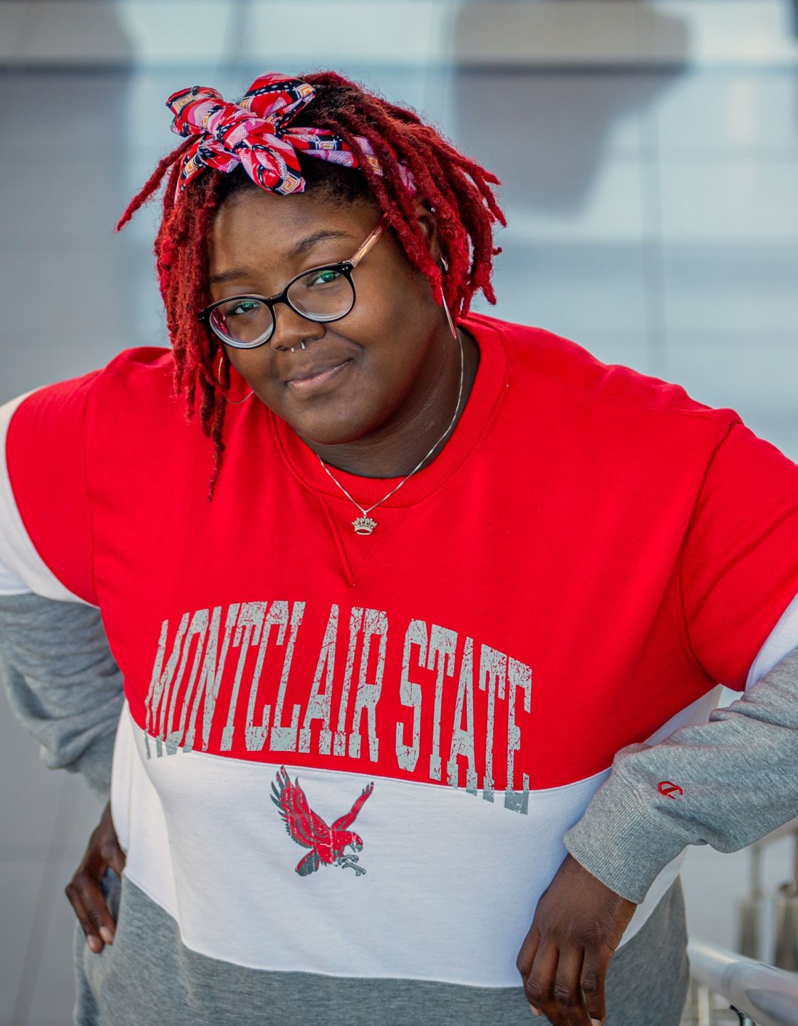 Khara Brown, class of 2025, leaning on railing in the Cole Hall atrium