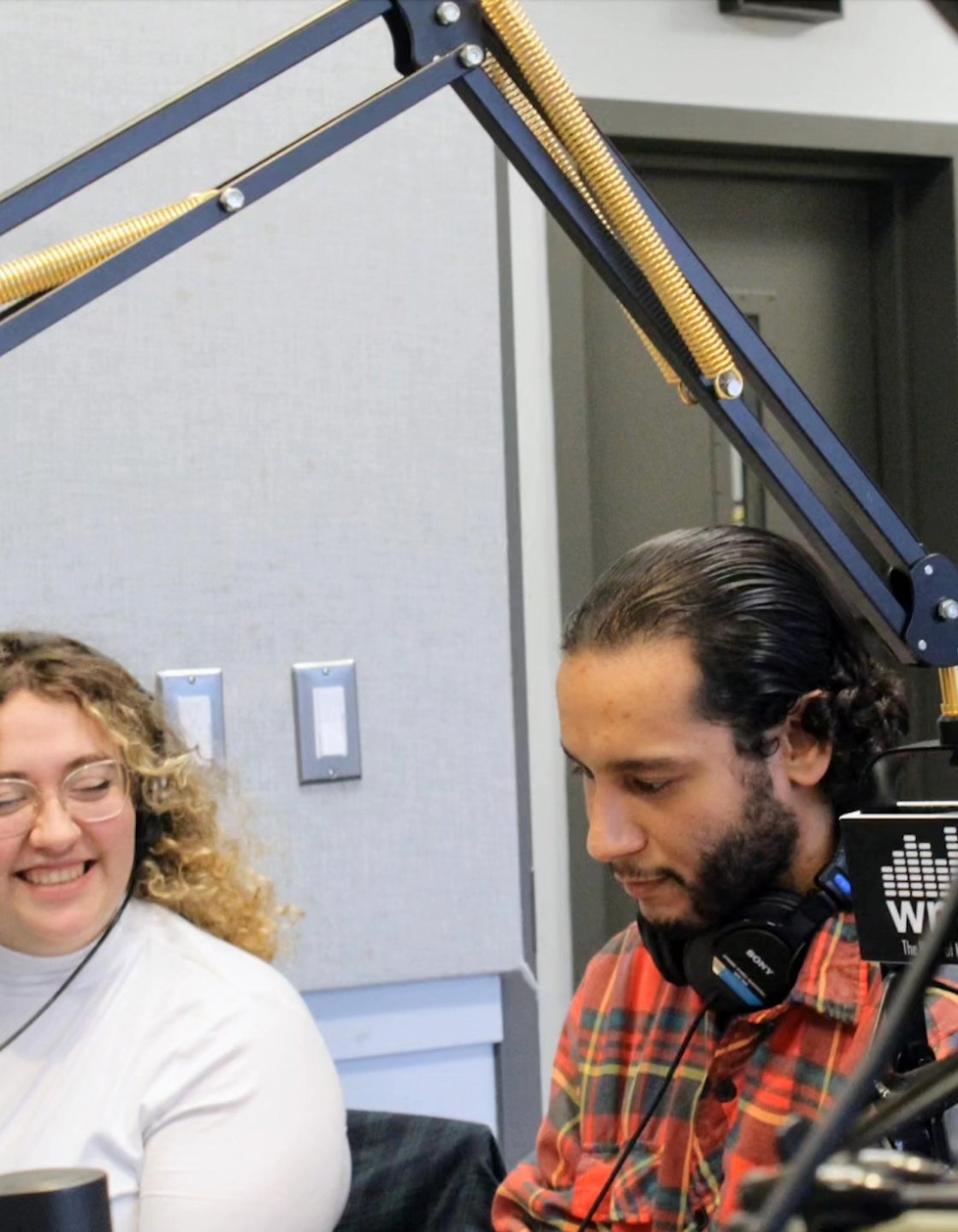 Two people working on a radio show.