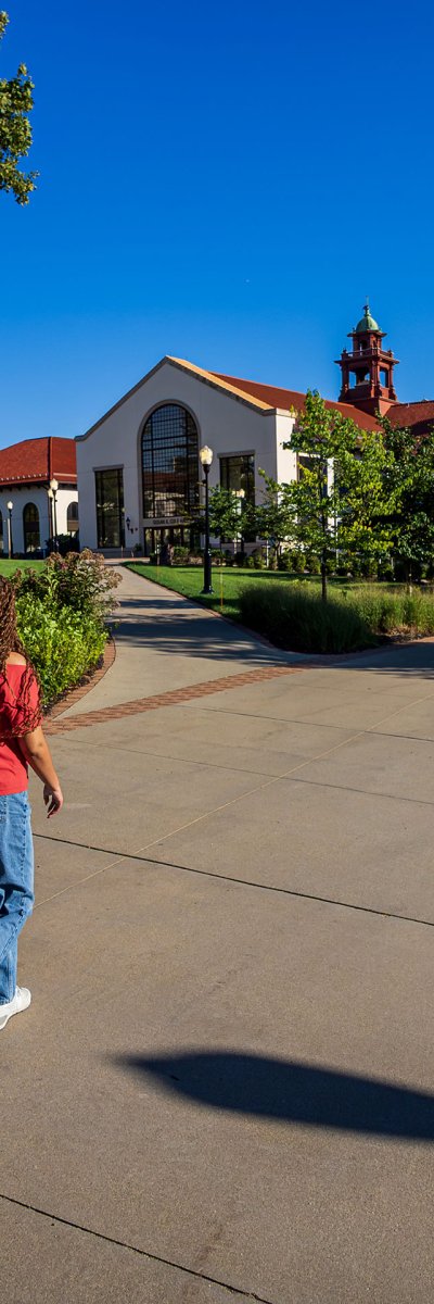 two students walking on paved path on Montclair campus