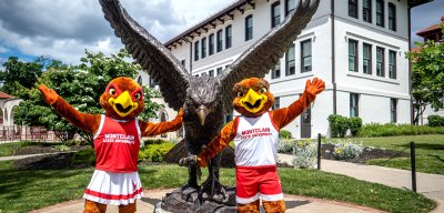 Rocky and Roxy in front of the Hawk statue on campus.