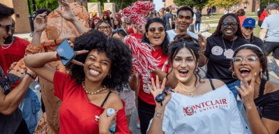 Group of student smiling and posing at Homecoming.
