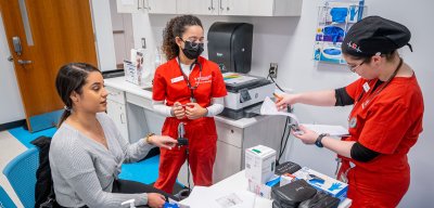 Three nursing students are collaborating together.