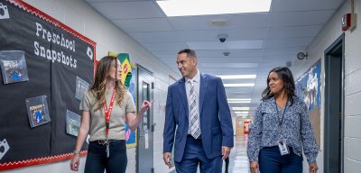 Three teachers walking down a hallway