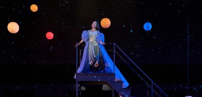 Student on stage in costume