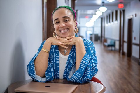 Cookie Howard sits at a table in a hallway in Susan A. Cole Hall.