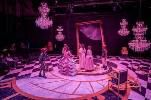 Actors on stage in a production of Marie Antoinette.