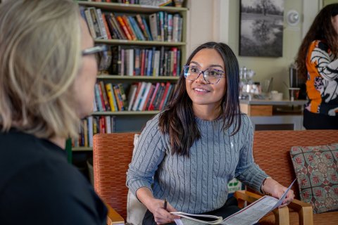 Montclair Public Health student Veronica Paniagua discusses Aging in Place volunteer program with a senior community member.