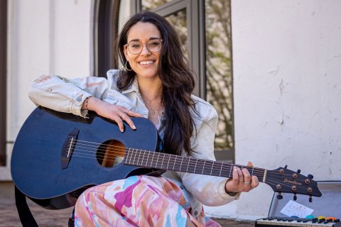 Alyssa Muñiz holds a guitar.
