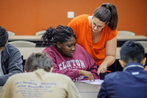 A college professor helps a student at Montclair State University.