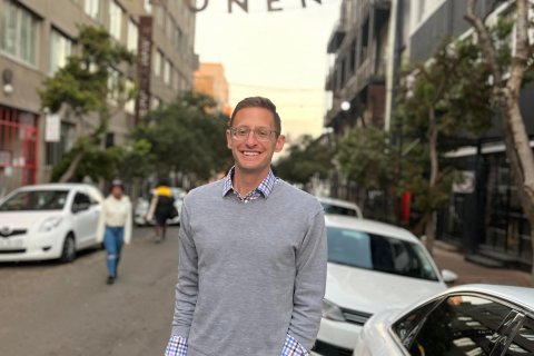Jason Torreano posing smiling.