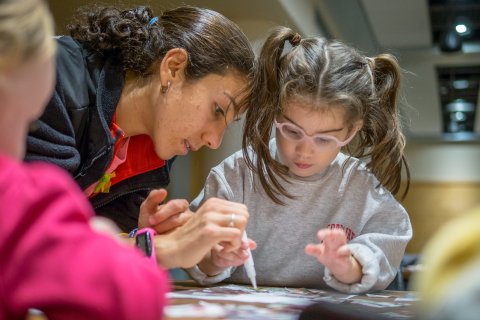 Teacher Working With Young Student at Classroom
