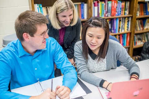Two students in discussion with instructor