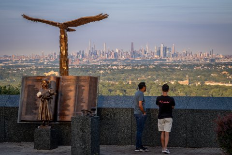 Visitors take in the Manhattan skyline view from the Eagle Rock Observation Deck.