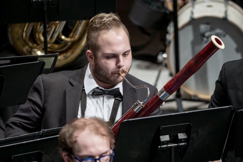 Bassoonist on stage performing with University Wind Symphony