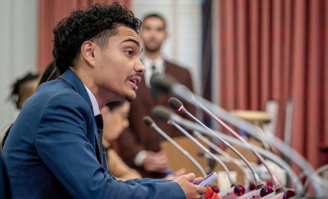 A student speaks into a microphone at the State House in Trenton, New Jersey.