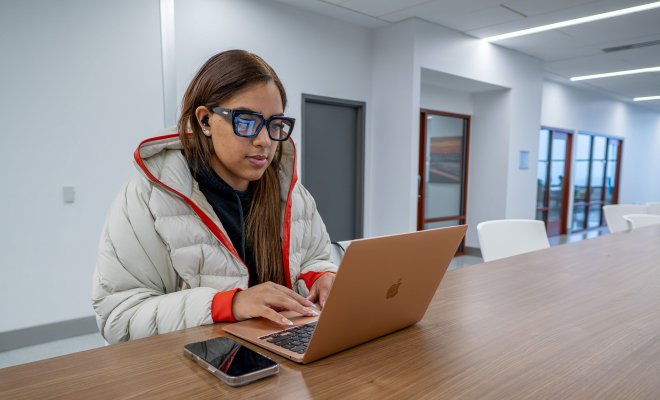 Student working on laptop.